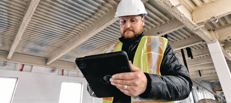 Cropped image of operations manager on a jobsite looking at a tablet. Cropped image of operations manager on a jobsite looking at a tablet.